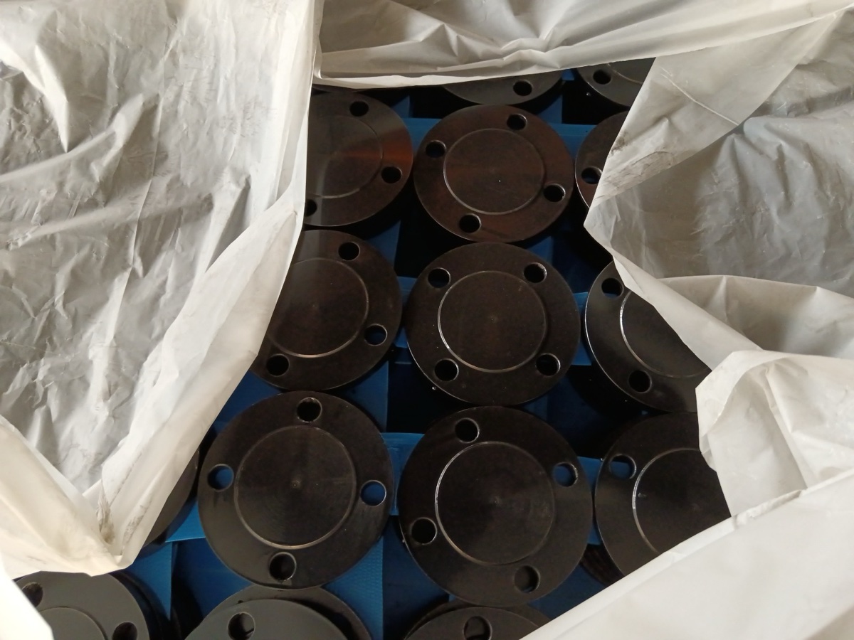 Black coated carbon steel raised face blind flanges packed in lined export crate