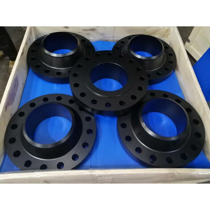 Black ASTM A182 F5 alloy steel weld neck and blind flanges packed in a lined wooden export crate — Tesco Steel & Engineering