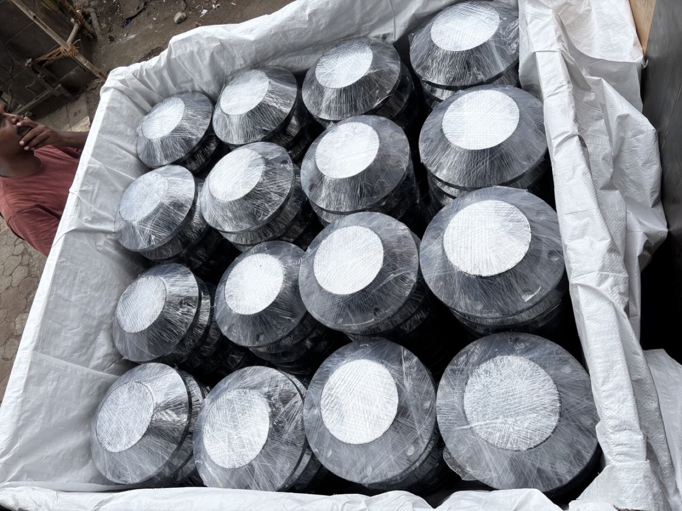 Black-coated ASTM A350 LF2 low temperature carbon steel flanges wrapped in a lined export crate — Tesco Steel & Engineering