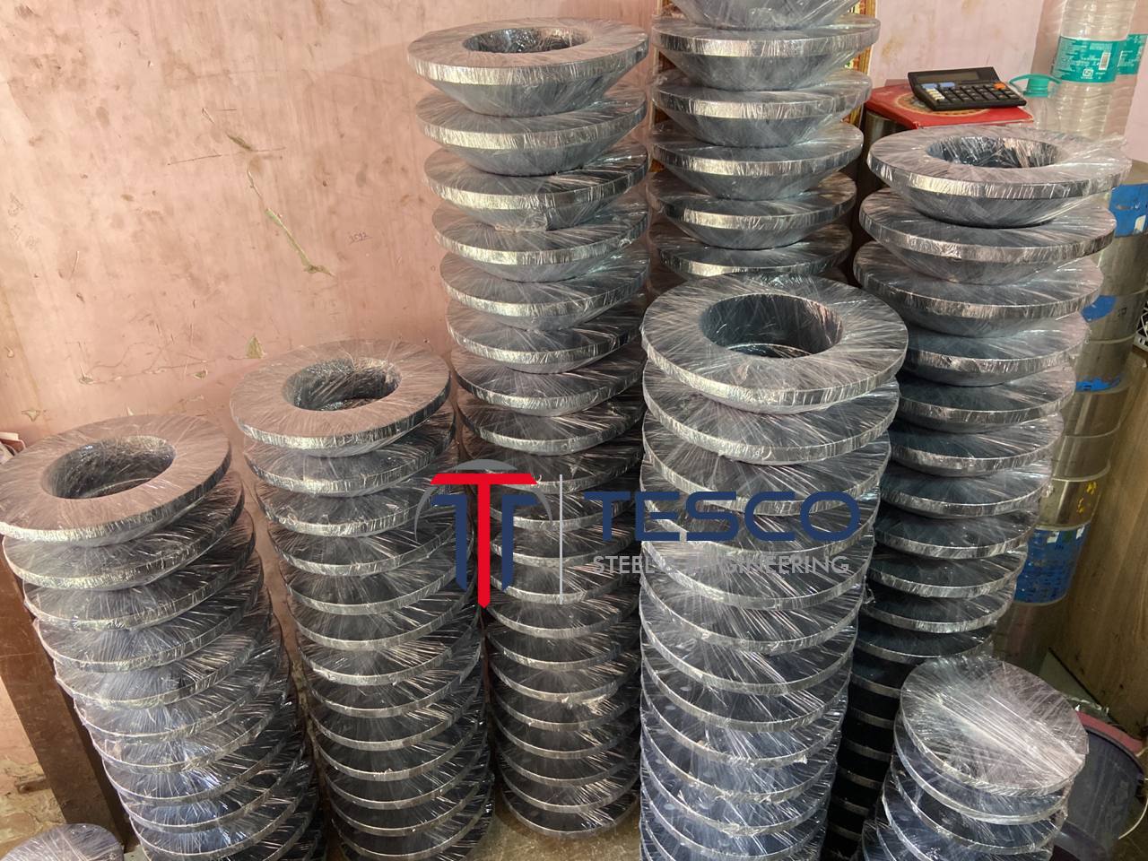 ASTM A350 LTCS low temperature carbon steel flanges bulk-stacked and plastic-wrapped ready for export dispatch — LF1 LF2 LF3 flanges manufacturer Mumbai India