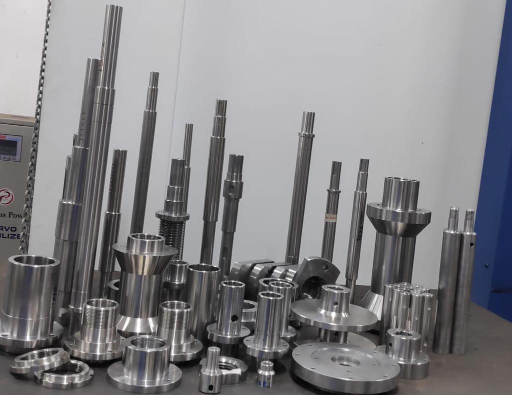Range of CNC machined components — turned shafts, spindles, bushes, flanged hubs and worm shafts in stainless and alloy steel by Tesco Steel & Engineering