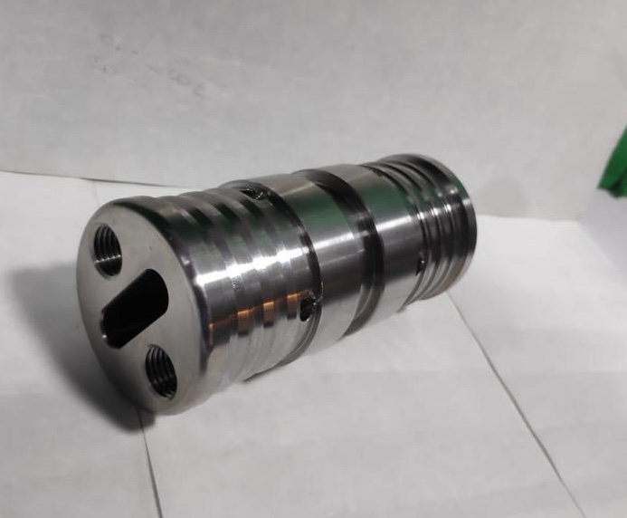CNC turned valve spool / cylindrical component with grooves, cross-drillings and tapped end machined from solid bar