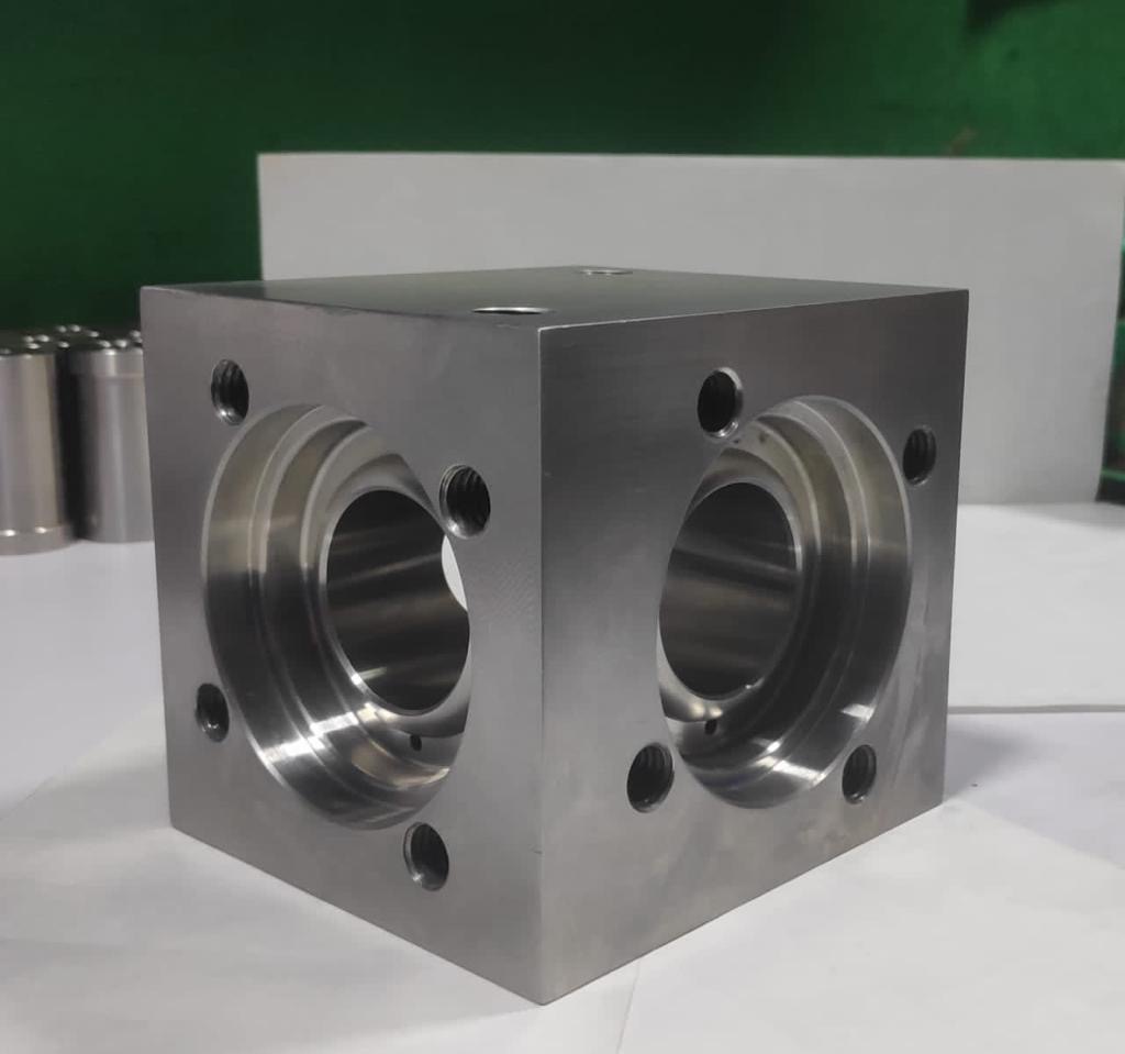 CNC milled manifold block / housing with precision bored flanged ports and tapped holes machined from solid