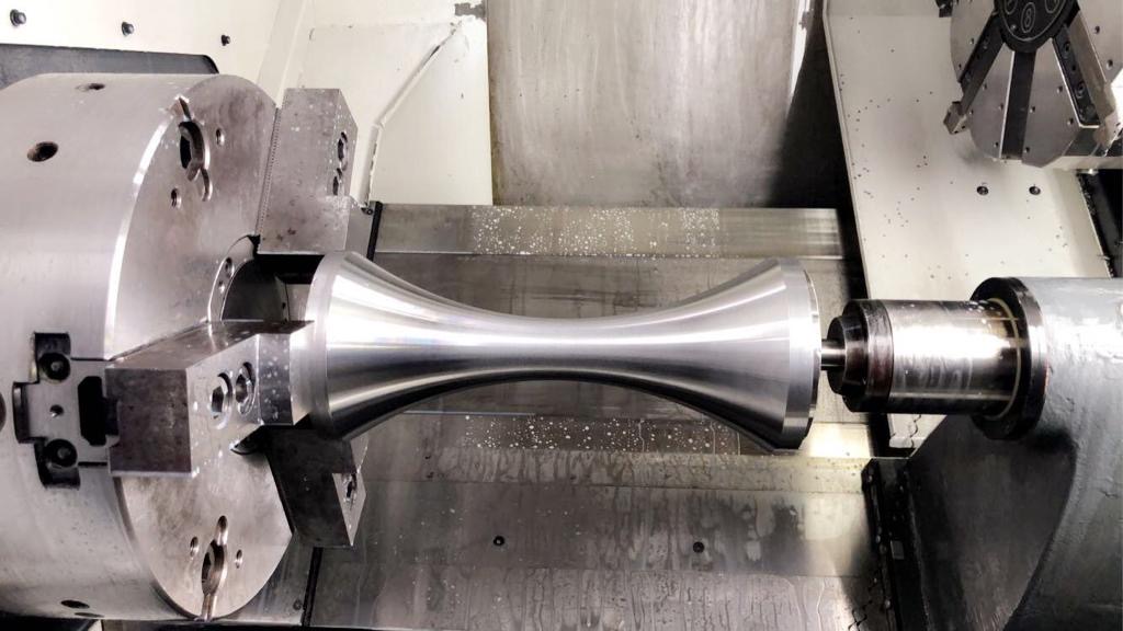 Precision component being turned on a twin-chuck CNC lathe — in-process CNC turning at Tesco Steel & Engineering machine shop