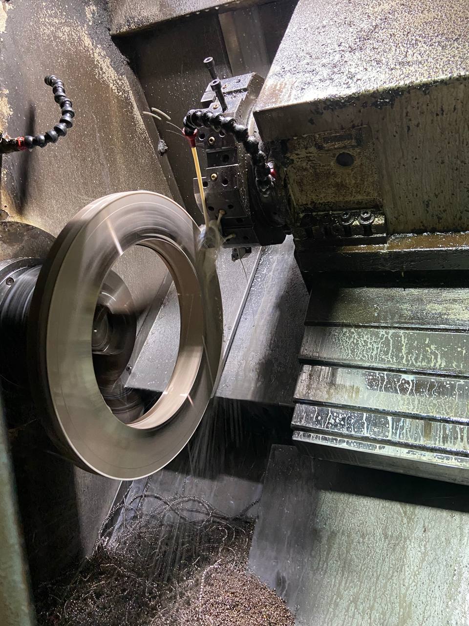 Cupro Nickel 90/10 flange being turned on CNC lathe with metal chips during precision manufacturing