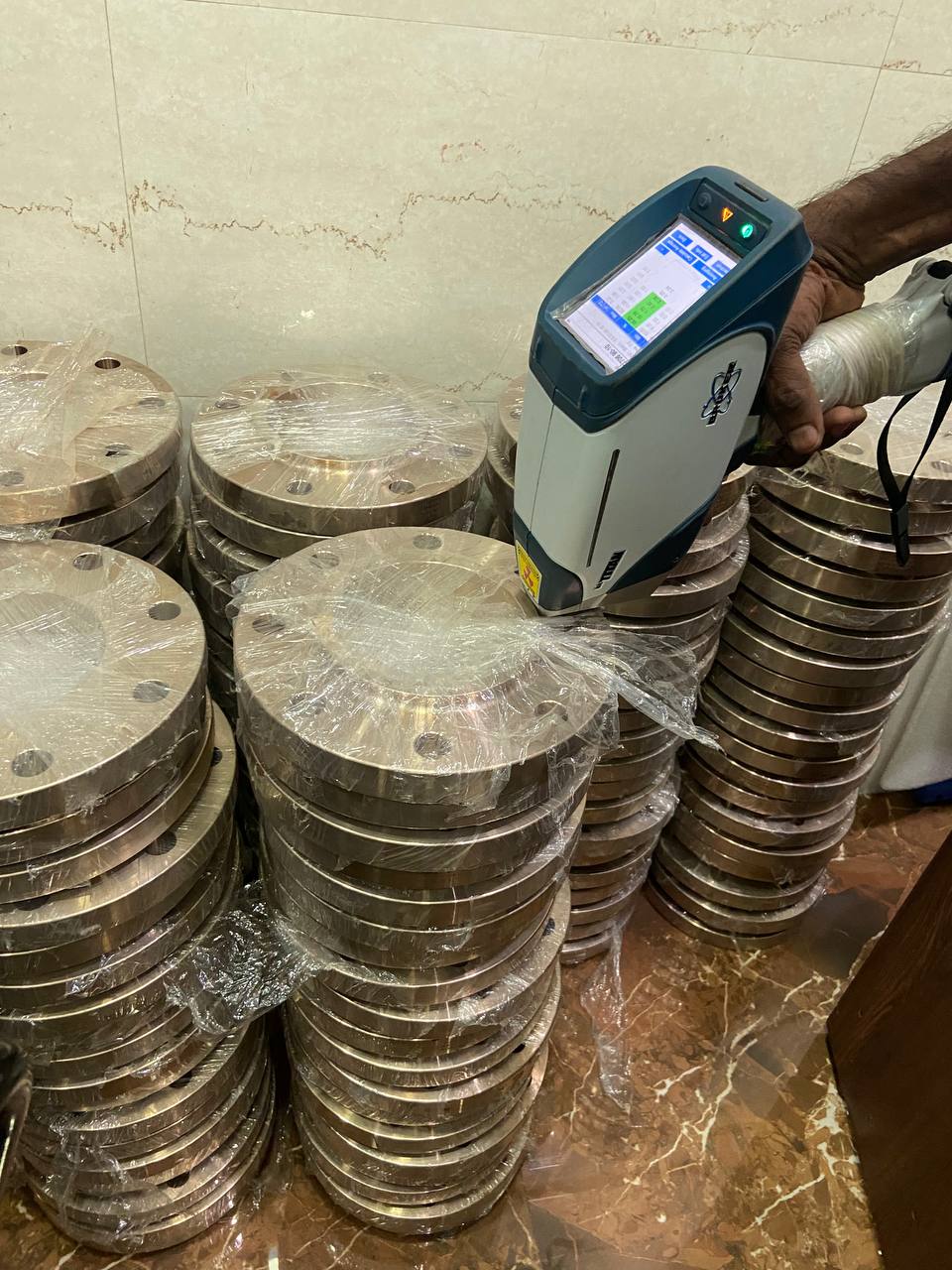 Positive Material Identification PMI testing of Cupro Nickel flanges using portable XRF analyser to verify Cu-Ni composition