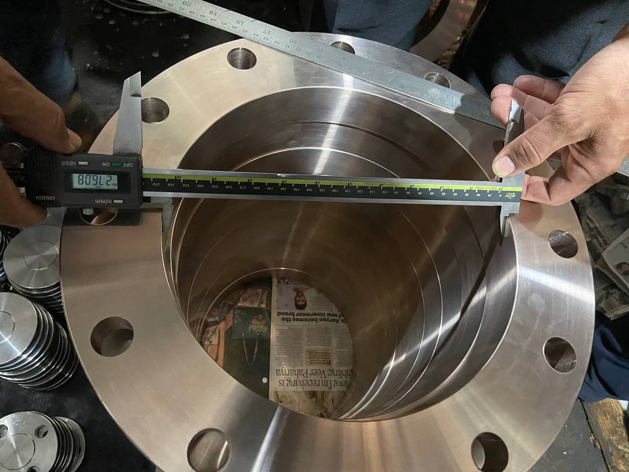 Quality inspection of Cupro Nickel weld neck flange bore diameter measured at 809 mm with digital vernier caliper