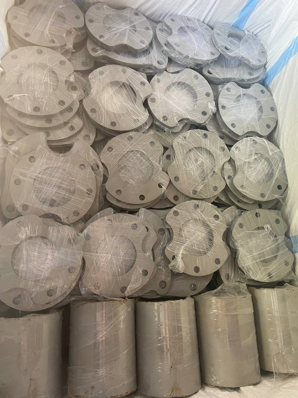 Mixed duplex steel blind and weld neck flanges plastic-wrapped in export shipping container — ASTM A182 F51 F53 F60, Tesco Steel & Engineering India