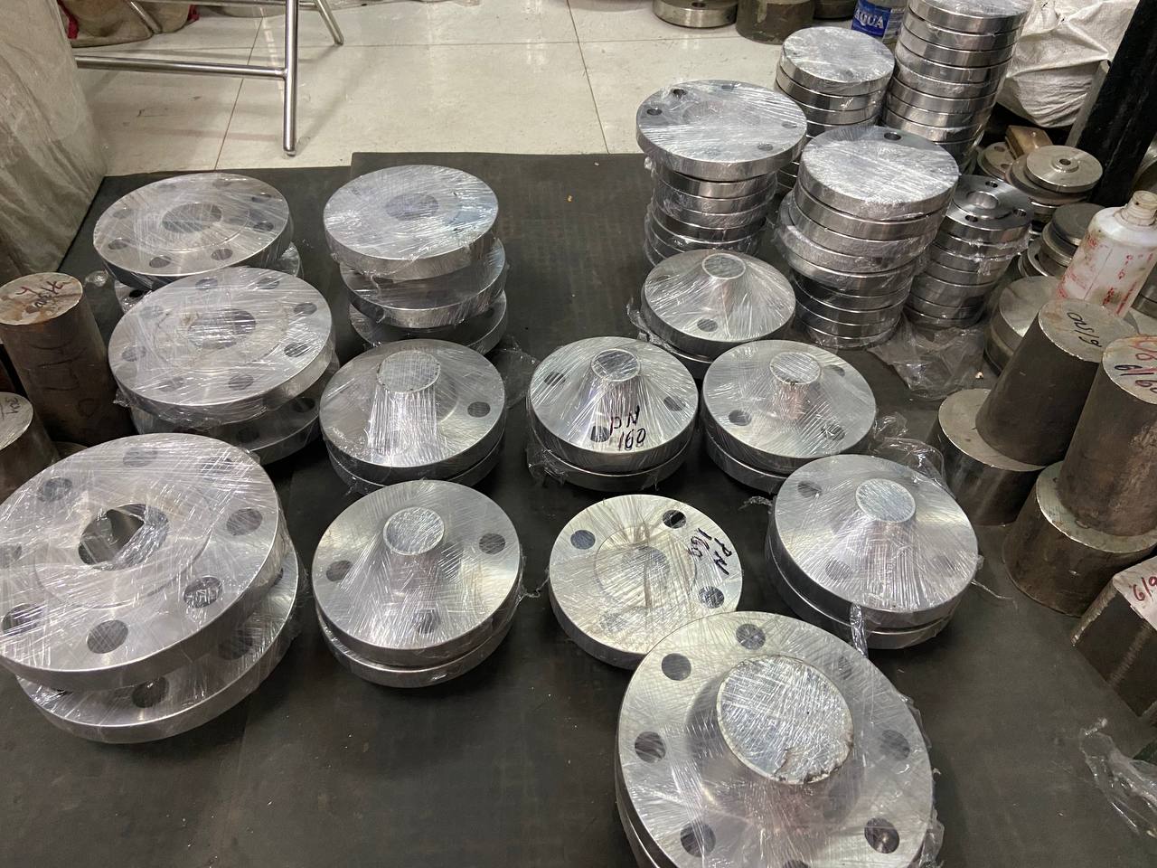 Duplex steel weld neck flanges in various sizes arranged on dispatch table before export packing — ASTM A182 F51 F53 F60, Tesco Steel & Engineering India