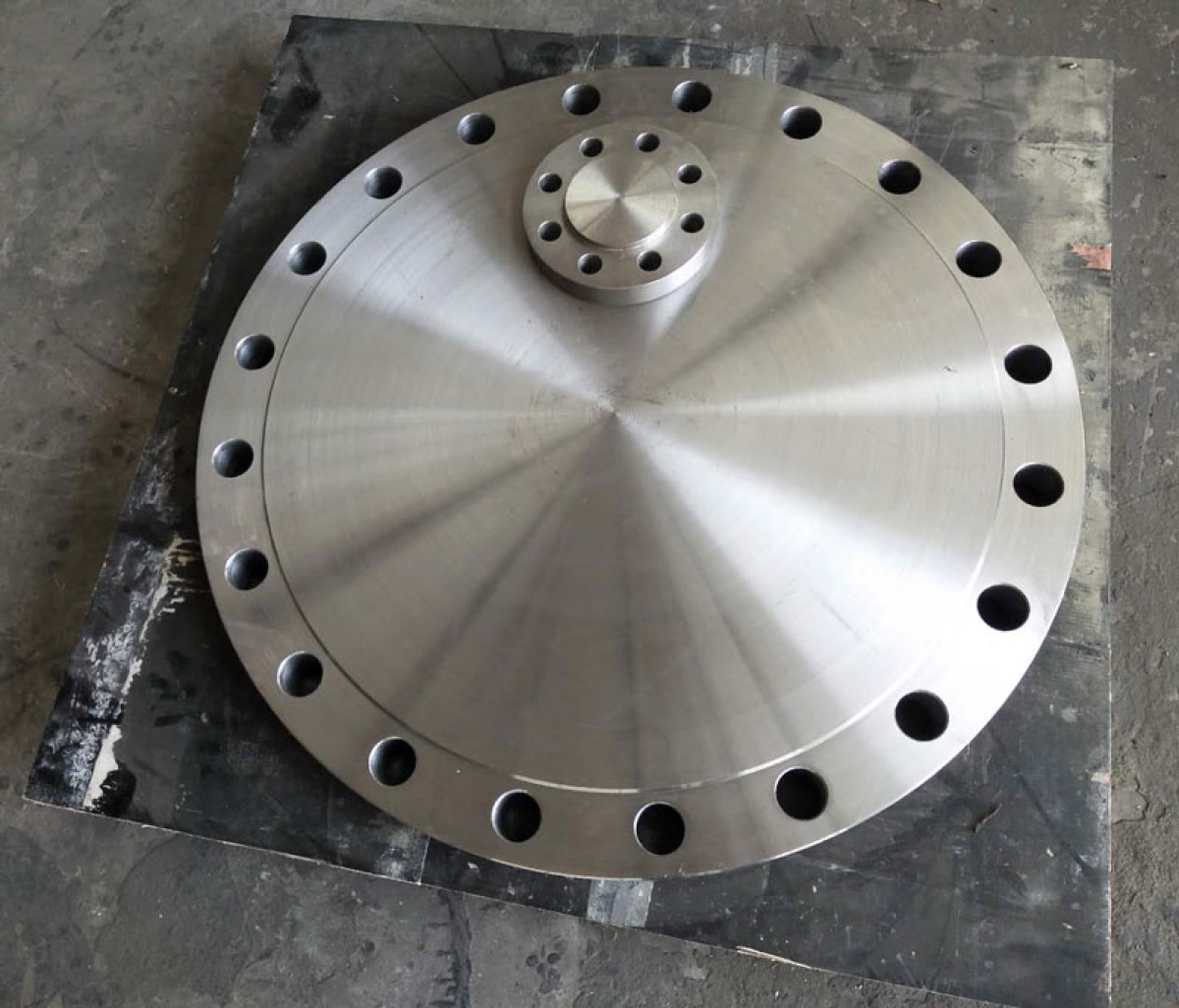 Large blind flange closing an auxiliary nozzle connection on process equipment