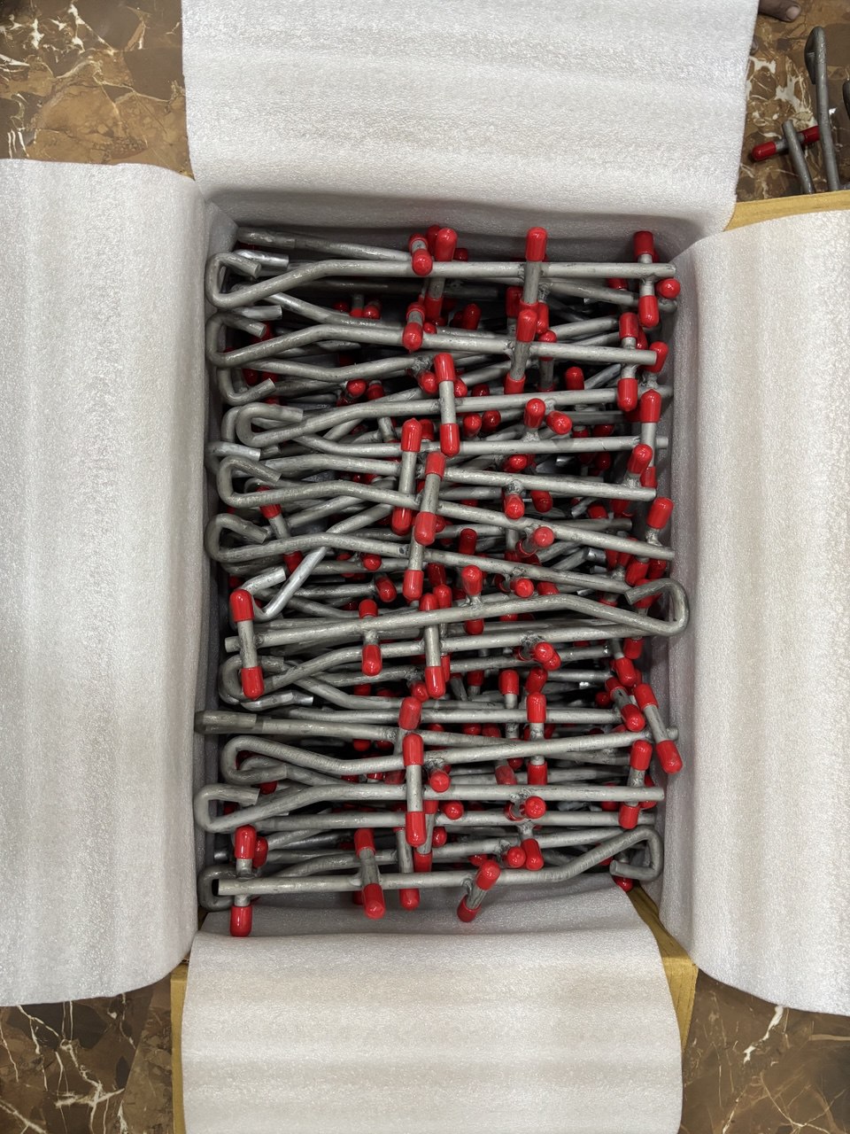 Refractory anchors foam-packed in an export carton