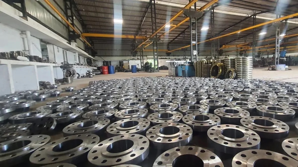 Factory floor covered with machined slip on flanges in production hall awaiting final inspection