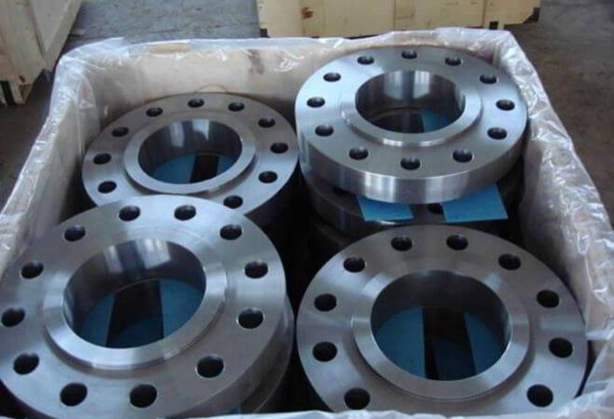 Raised face SORF slip on flanges packed with separators in film-lined wooden export crate