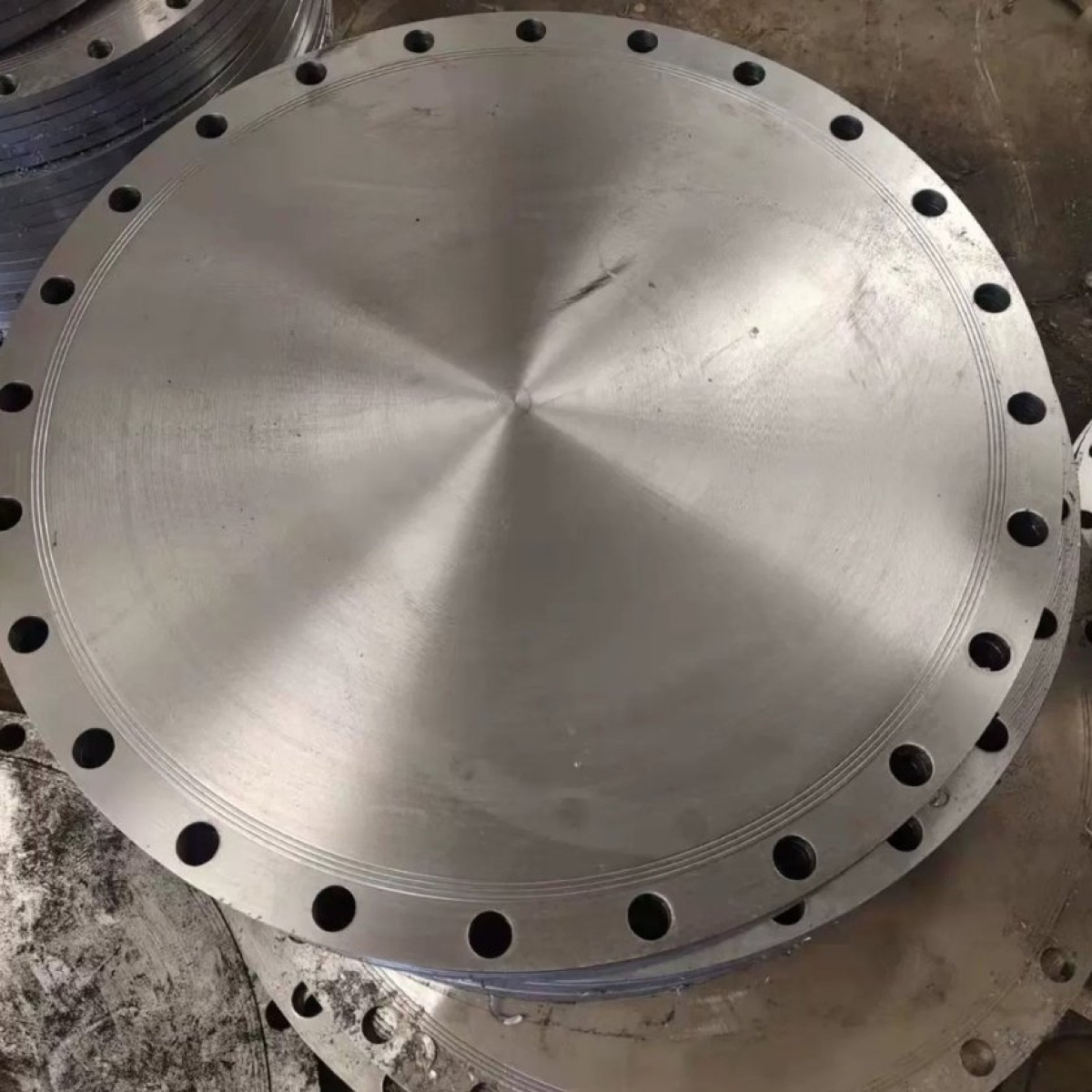Large machined stainless steel blind flange with concentric face finish at the works
