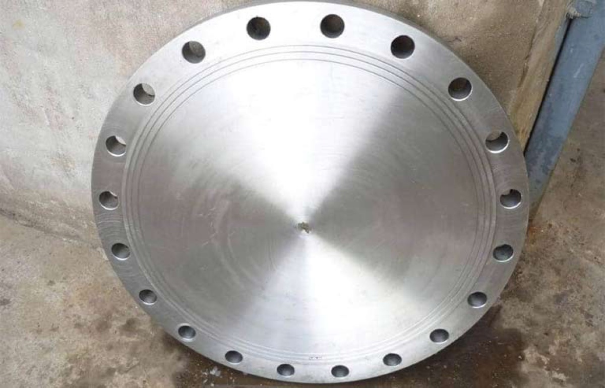Machined stainless steel blind flange with clean raised face at the works