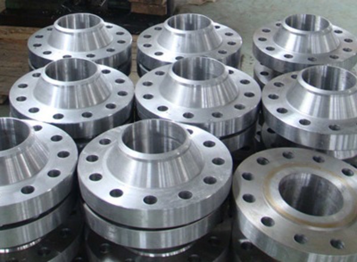 Titanium Grade 2 weld neck flanges machined and stacked in production — Tesco Steel & Engineering